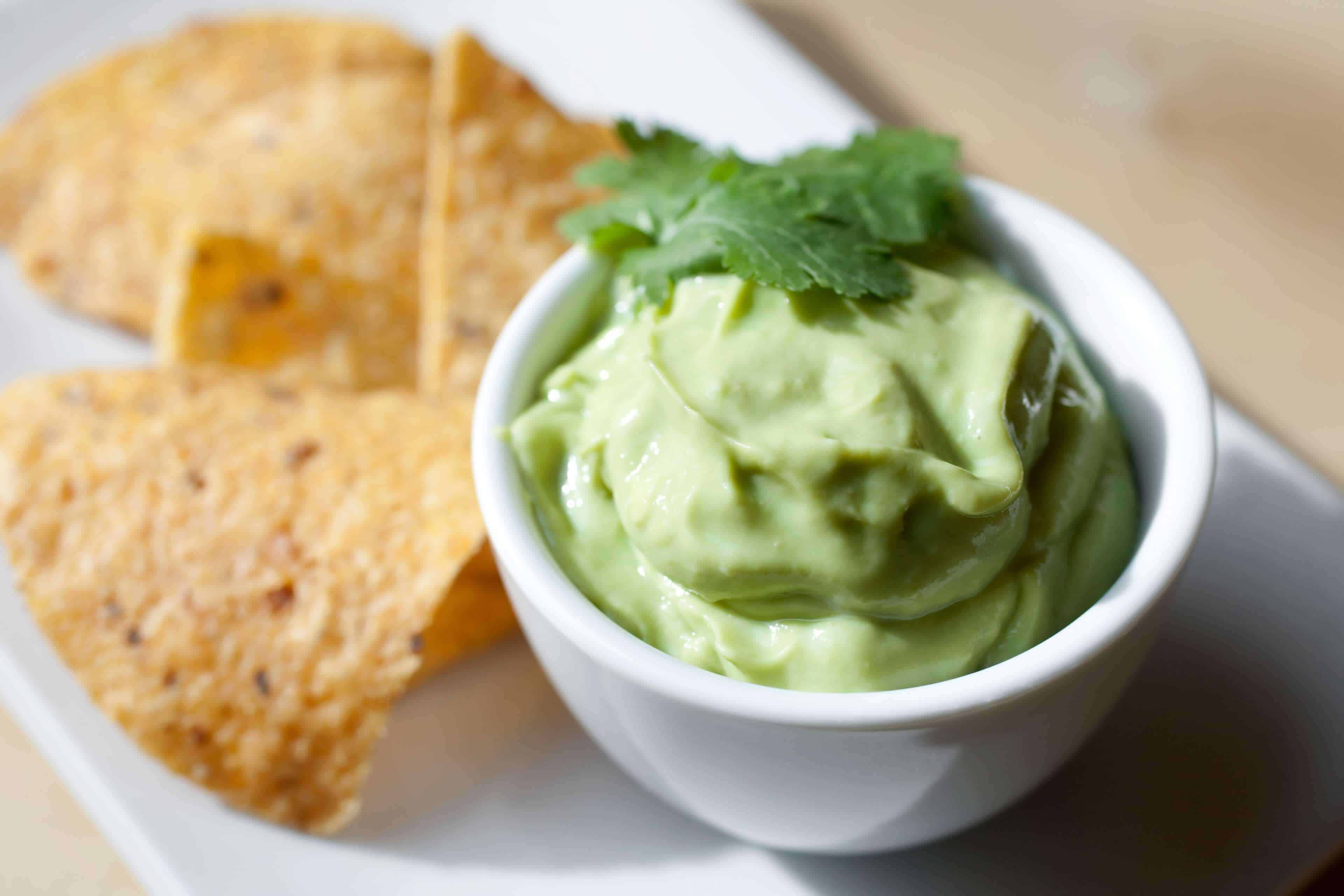 Guacamole with a twist: guacamole. Served in a bowl with corn chips.