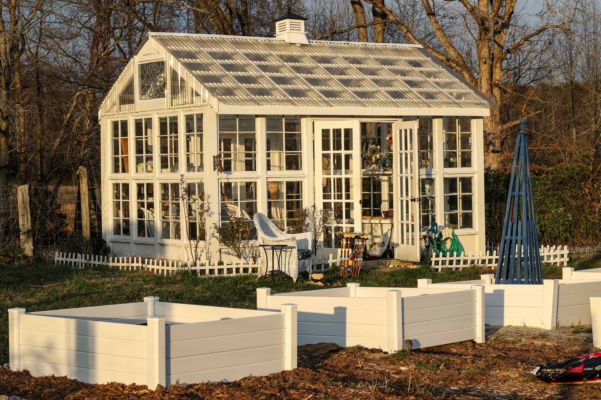 A freestanding greenhouse of individual panes of glass