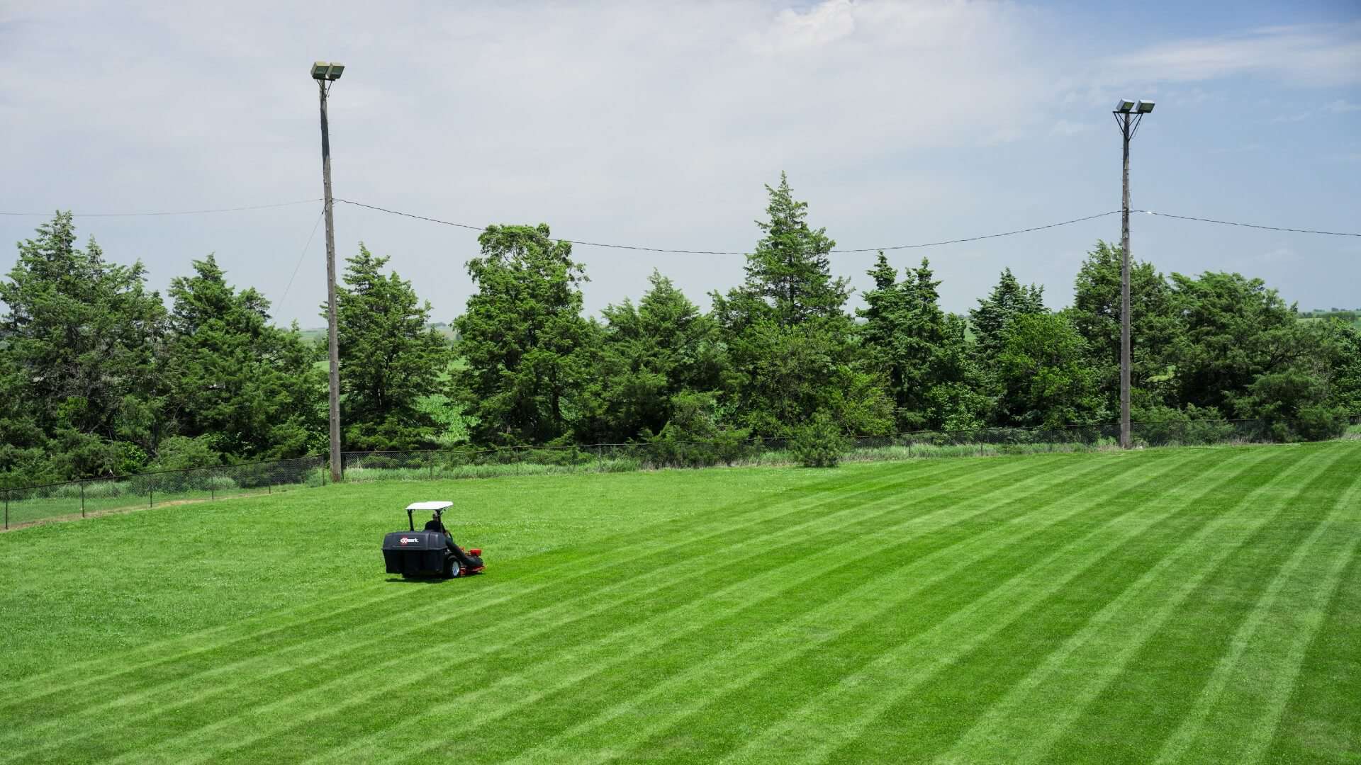 An Exmark mower striping a lawn