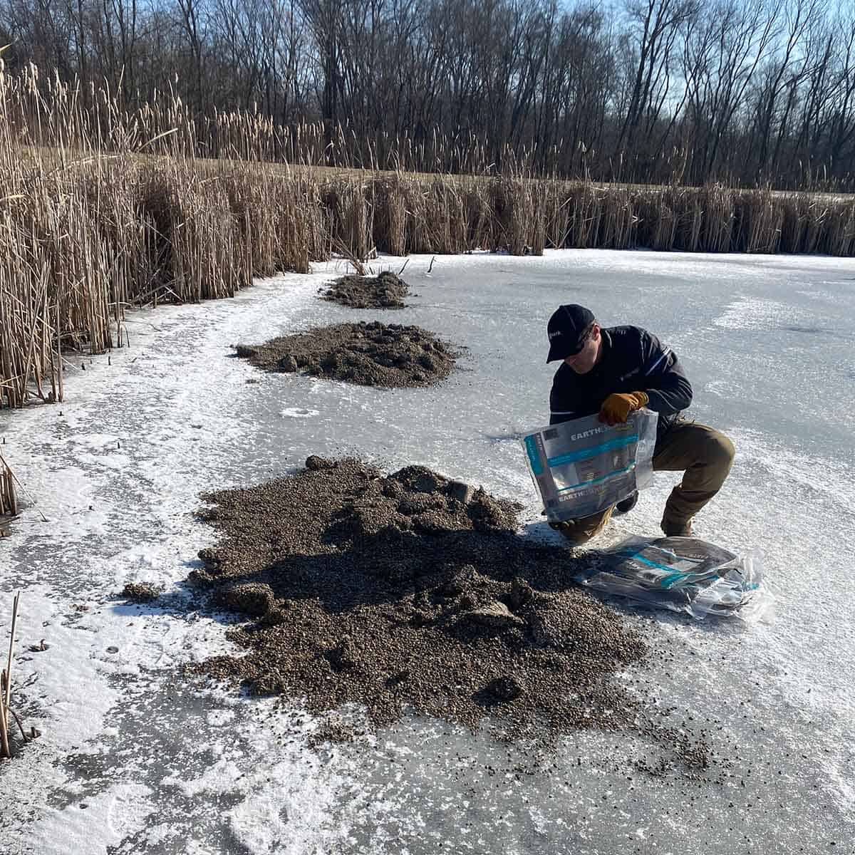 Joe maintaining pond in winter