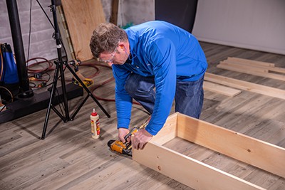 Using nail gun to secure sides of table together
