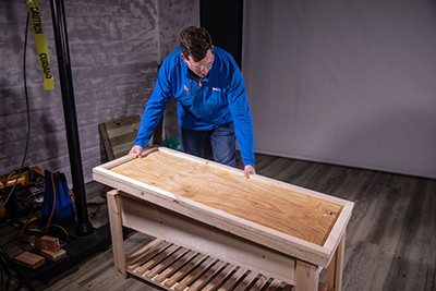 Placing lid on top of completed sandbox table