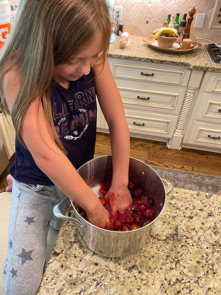 Girl helping with canning plums