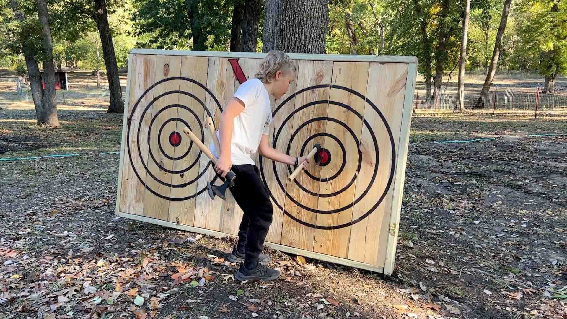 Daniel Arms' son with the completed axe throwing target