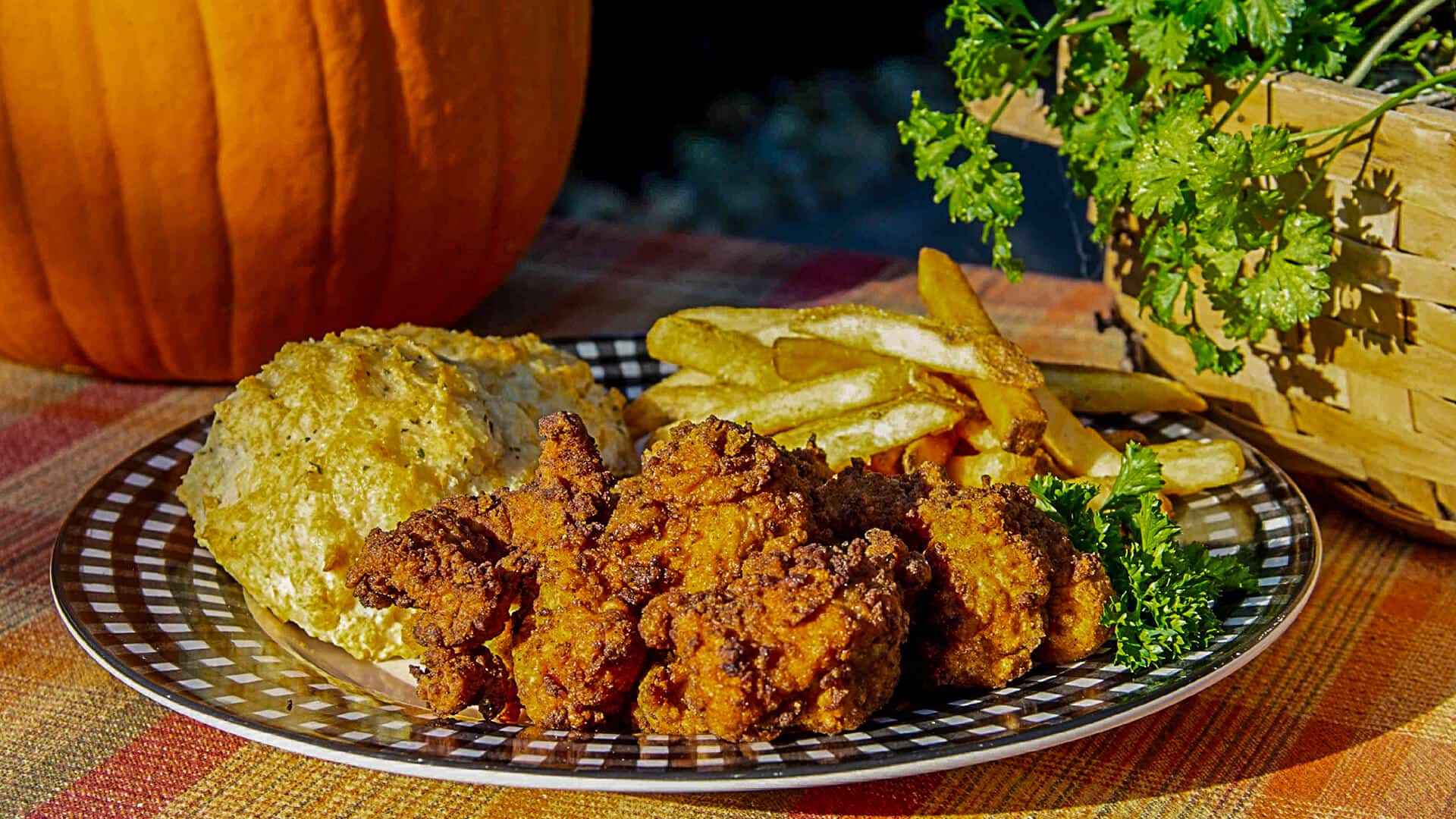 A plate of turkey nuggets, french fries, parsley, and bread