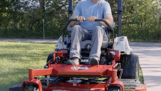 Andy Morgan mowing lawn