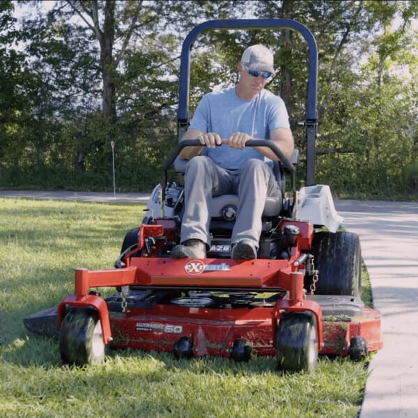 Andy Morgan mowing lawn