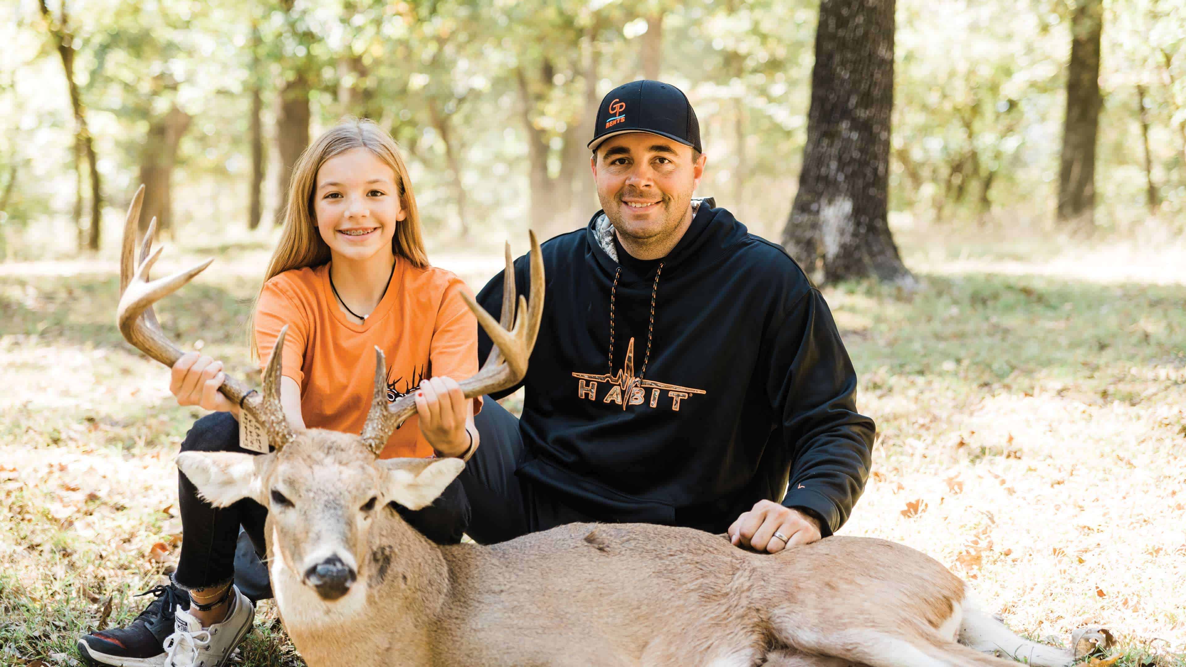 Daniel Arms and daughter holding harvested deer