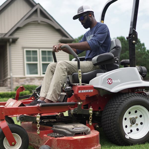 Brian Latimer mowing in front of his house