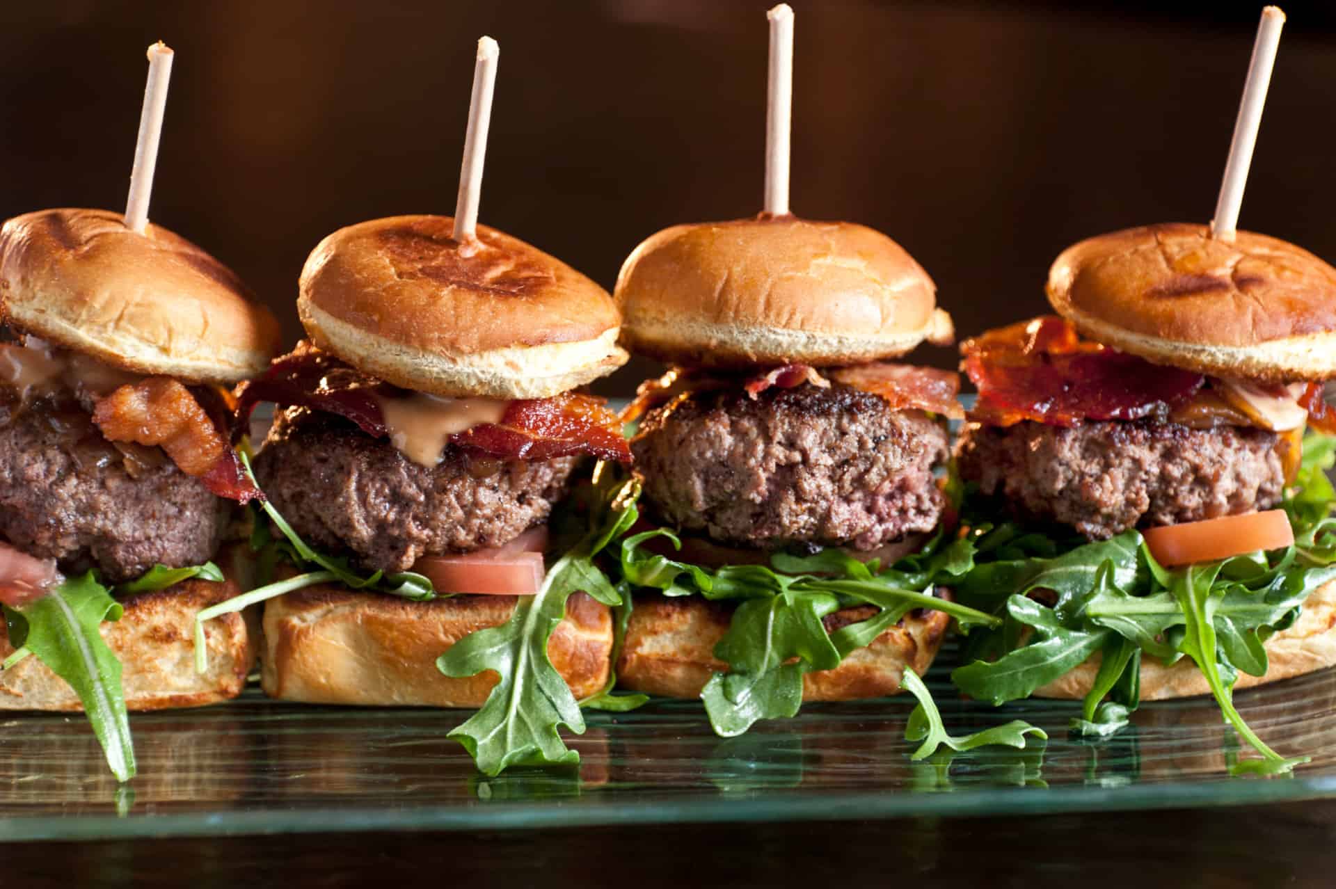 Four game day sliders on a plate.