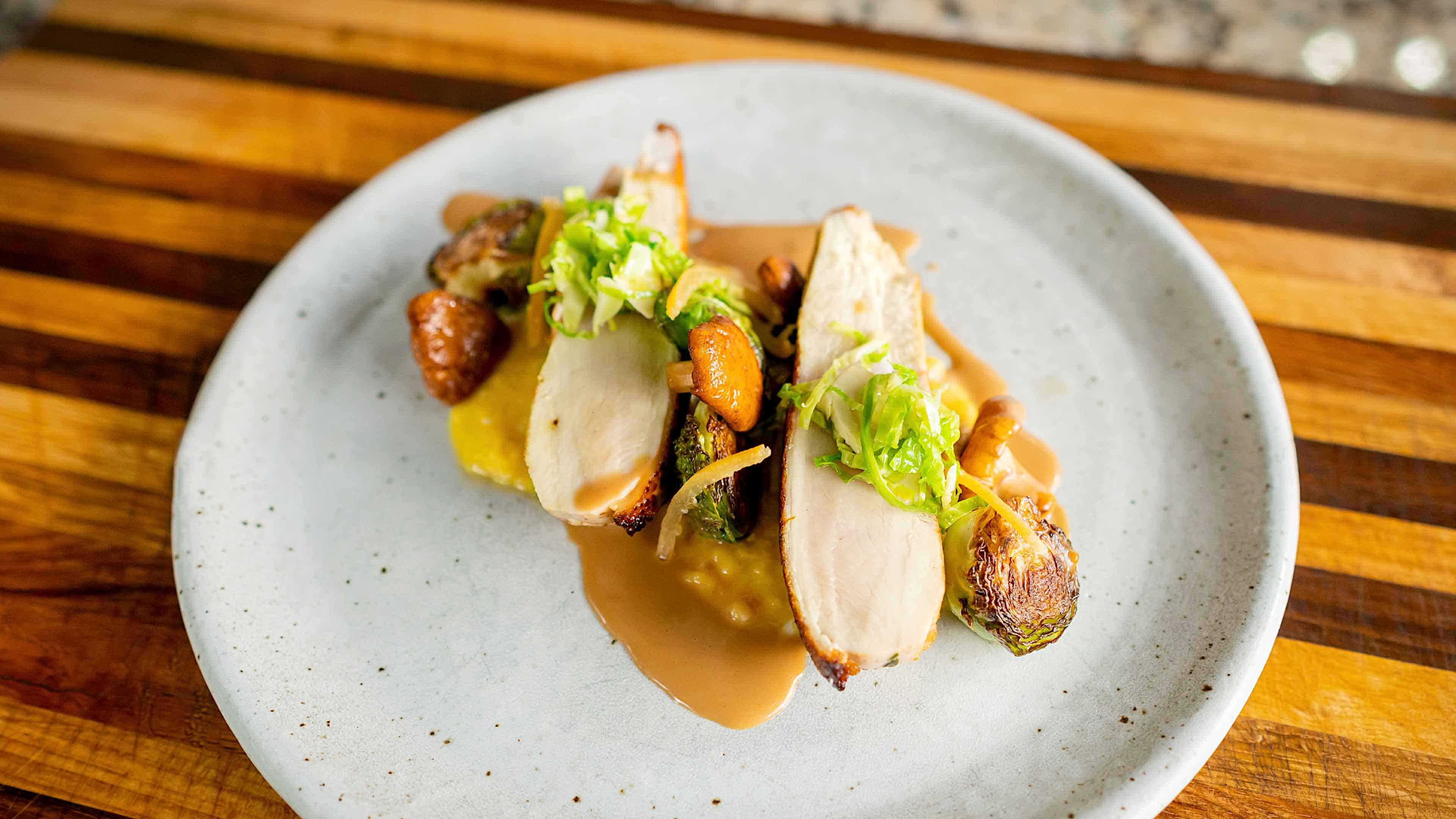 Grilled chicken and brussels sprouts on dinner plate