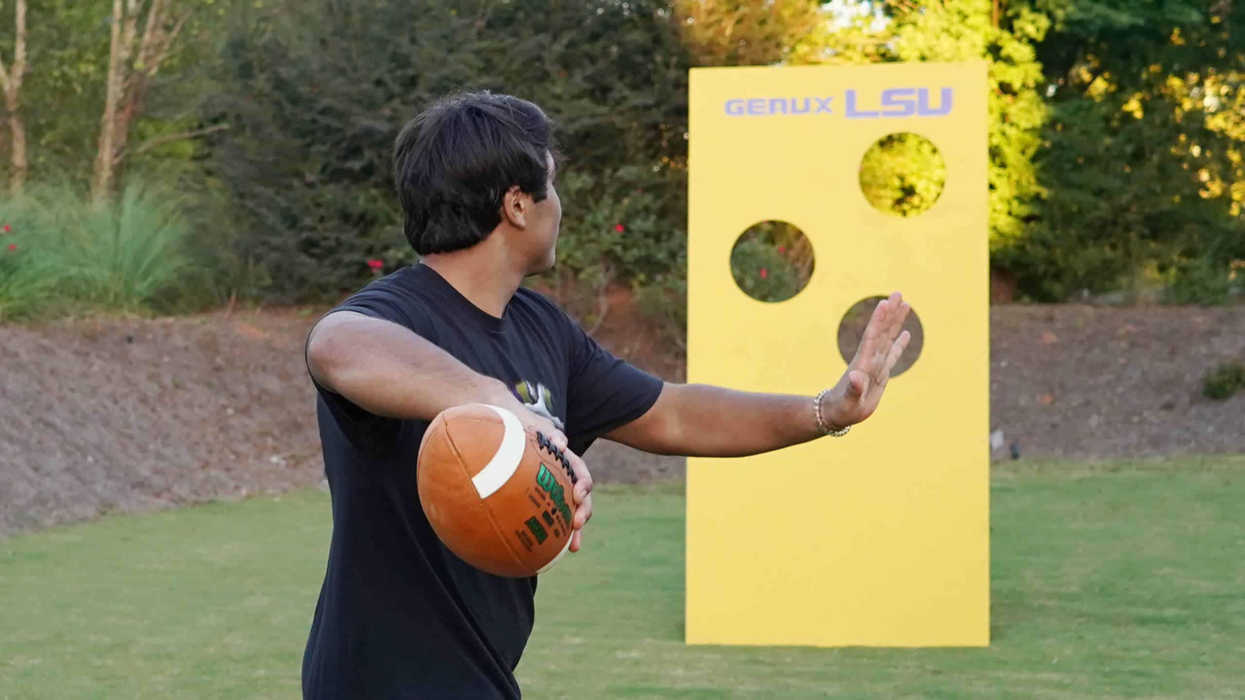Man throwing football through holes