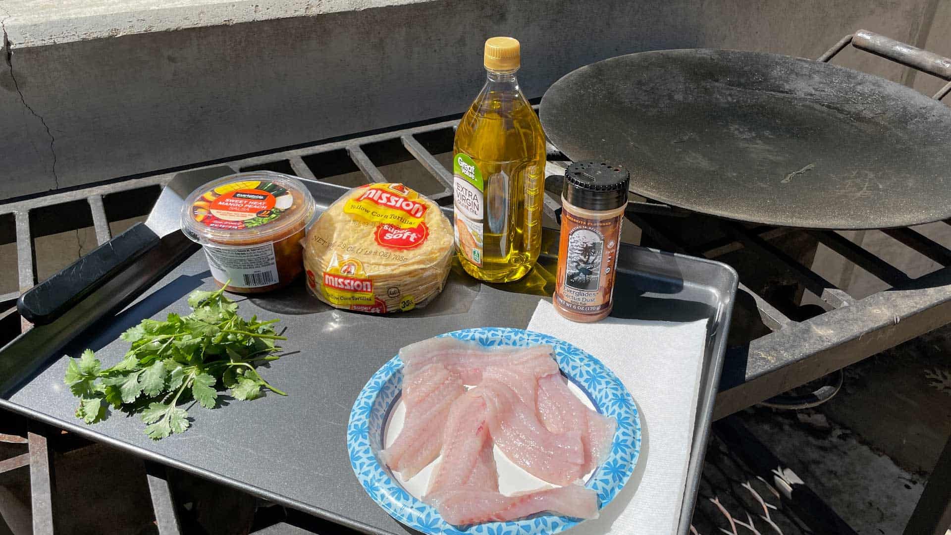 Delicious white bass fish tacos being prepared on the grill. 