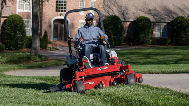 Brian Latimer mowing lawn