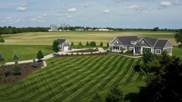 Family house with farm in back of field