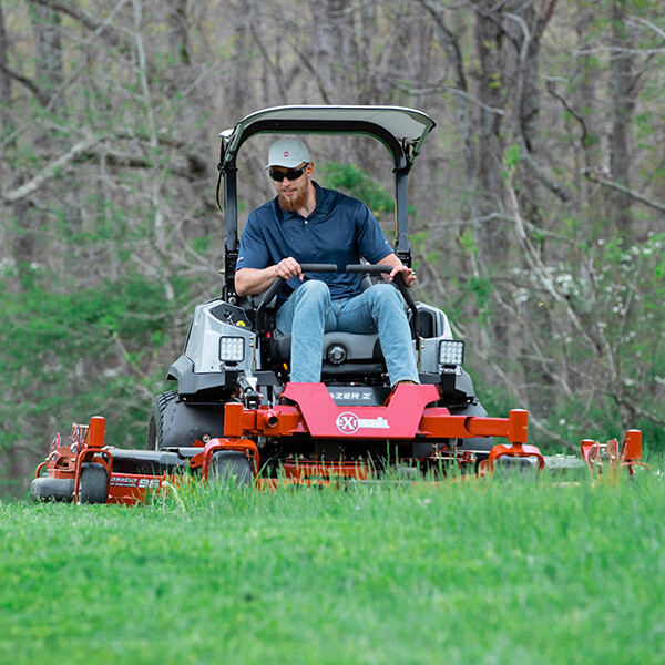 George Kittle riding Exmark mower