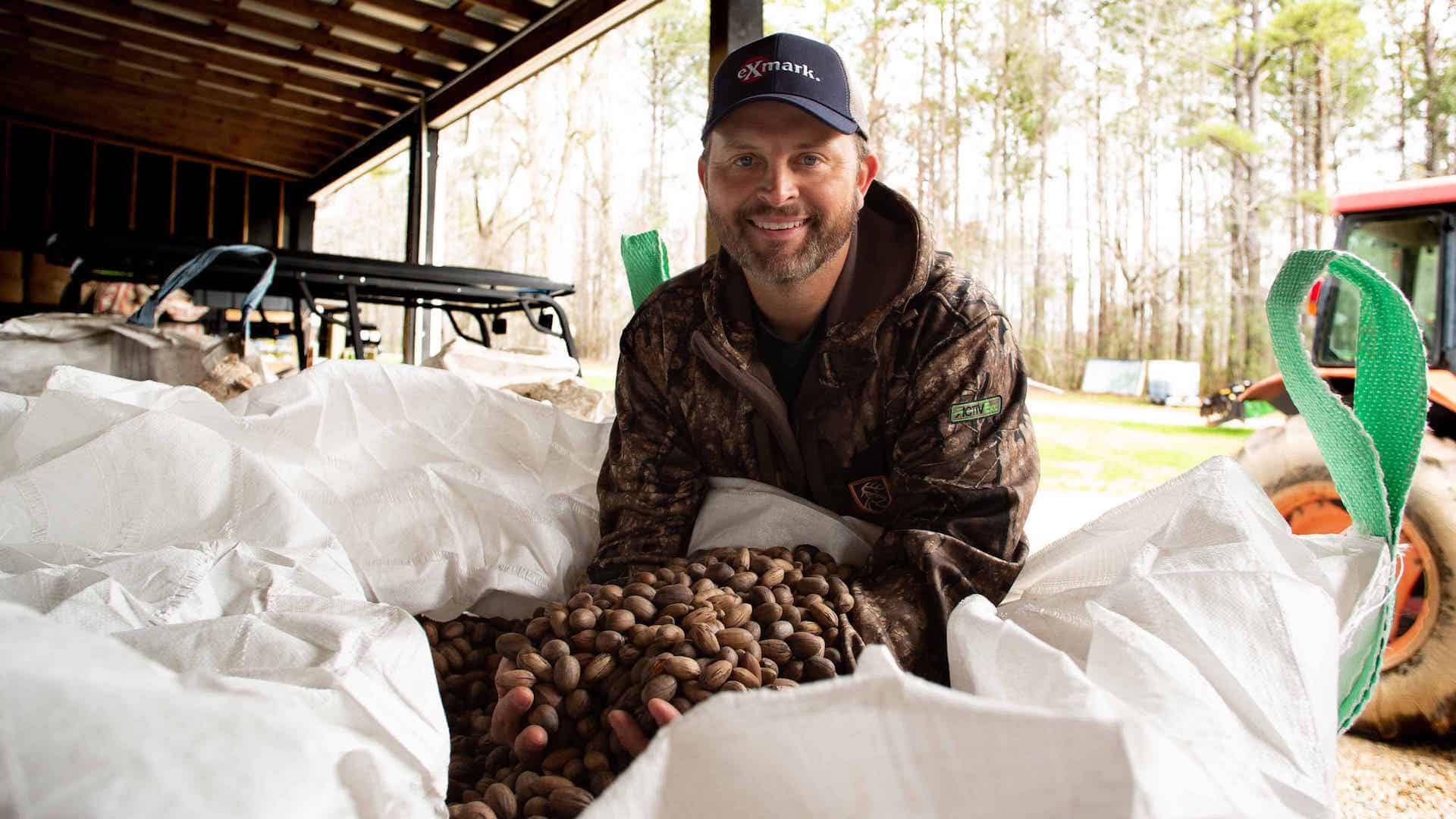 Mike Waddell holding harvested pecans in bag