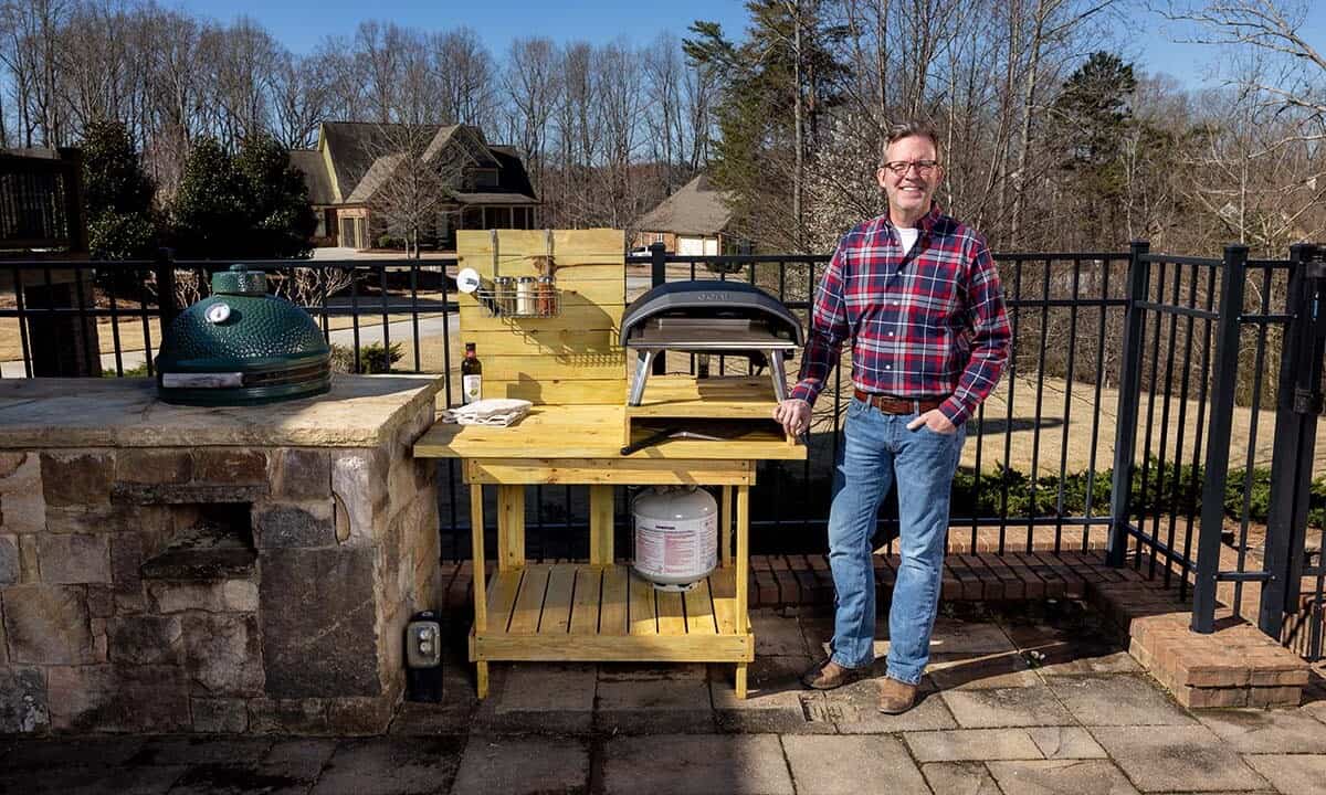 Doug Scott next to completed pizza oven