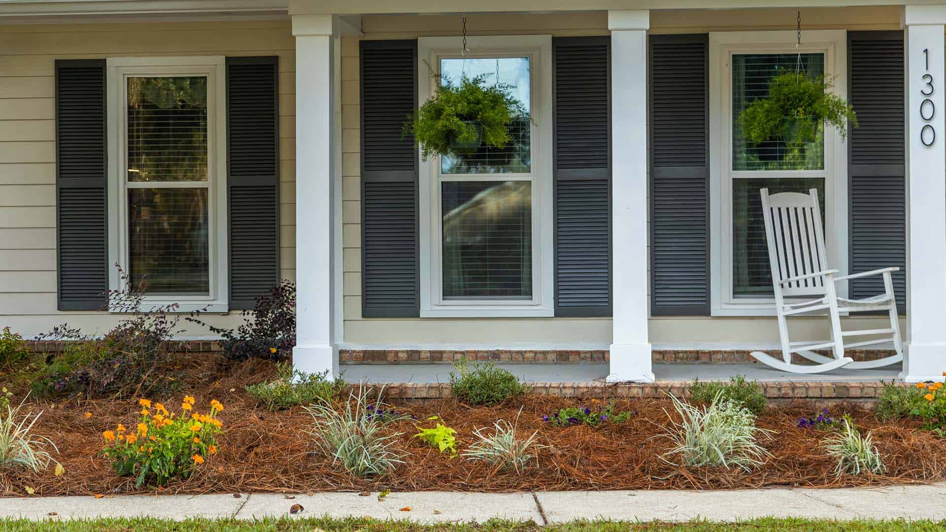 A front porch with no railing and new landscaping