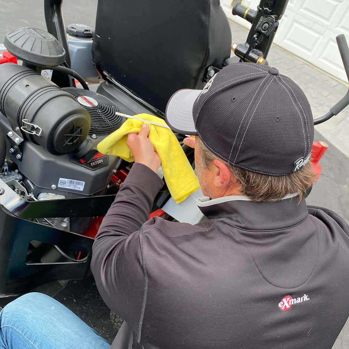 Joe performing maintenance on his Exmark mower