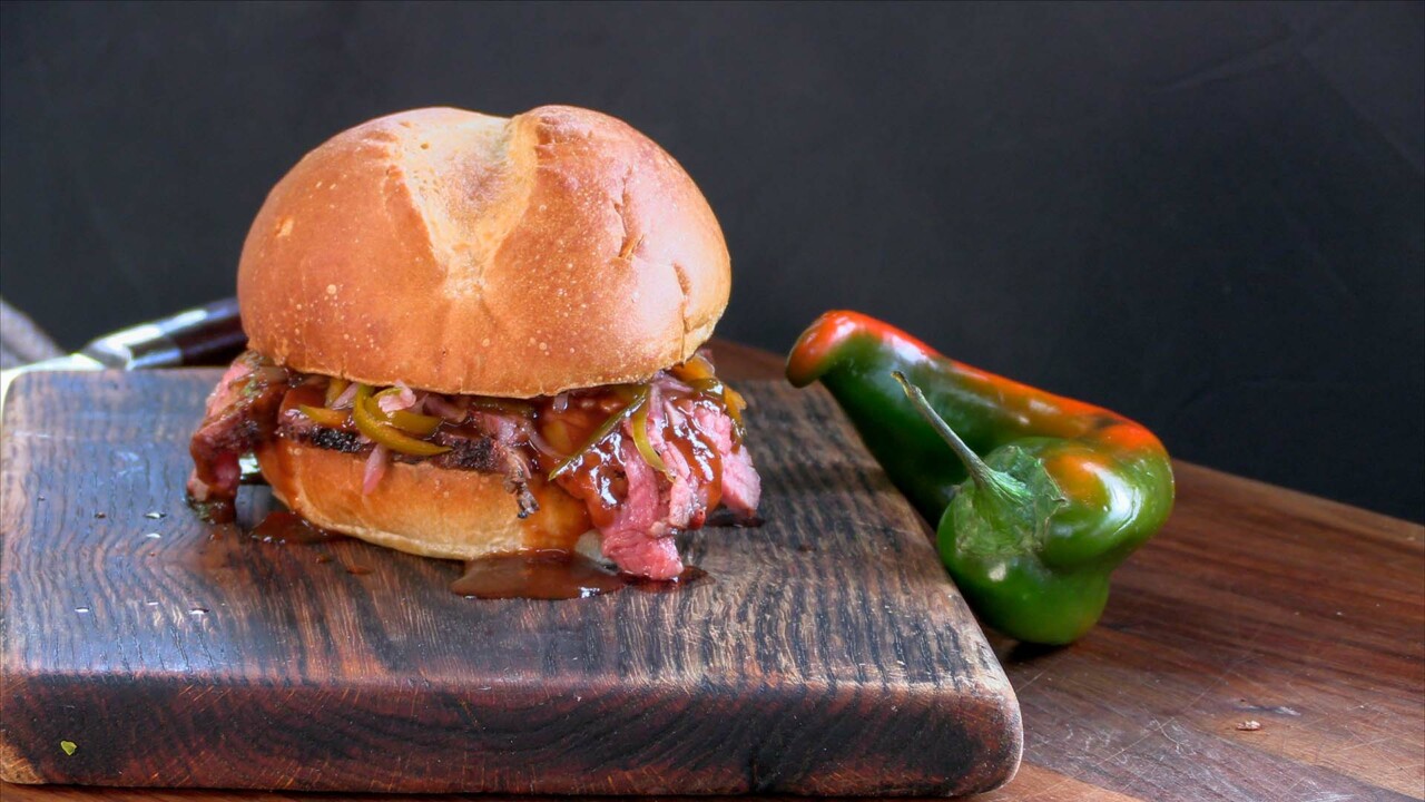 Tri-Tip BBQ Sandwich on cutting board with peppers