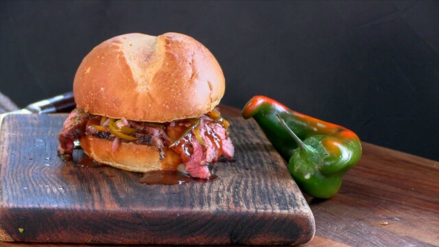 Tri-Tip BBQ Sandwich on cutting board with peppers