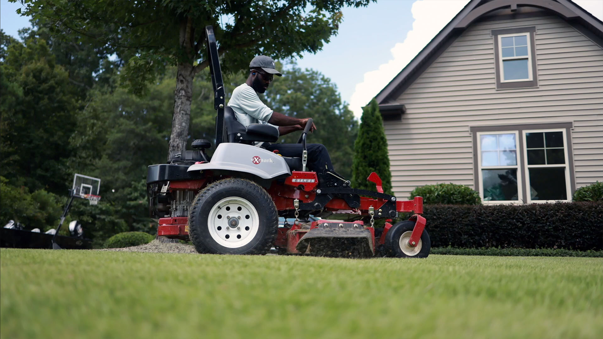 Brian Latimer riding lawn mower to prep lawn for spring