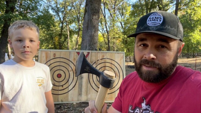 Daniel Arms and son with axe throwing target