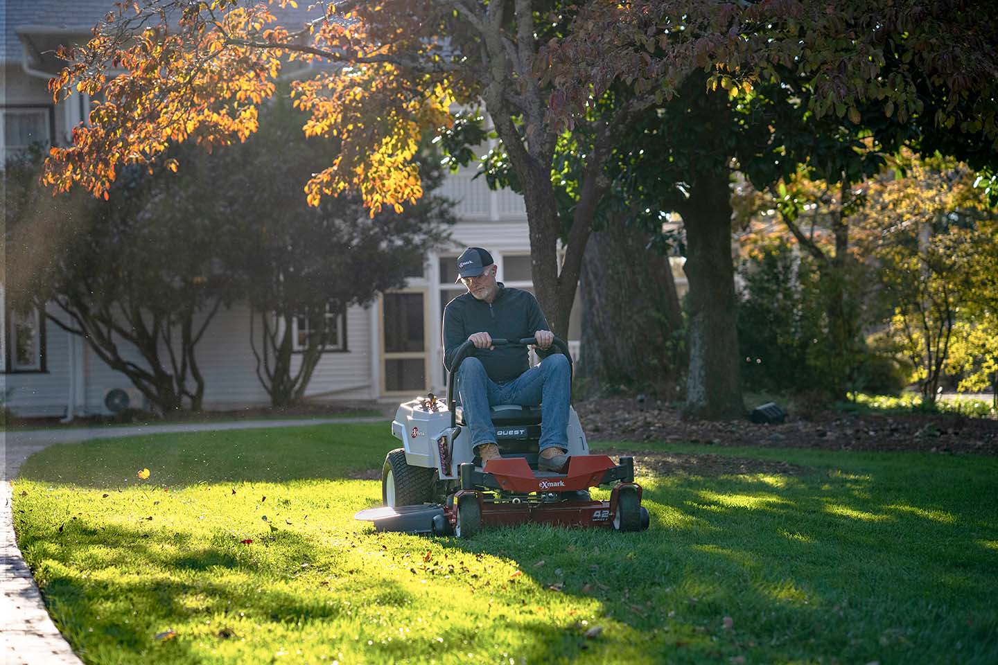 Man mowing front yard on Exmark mower