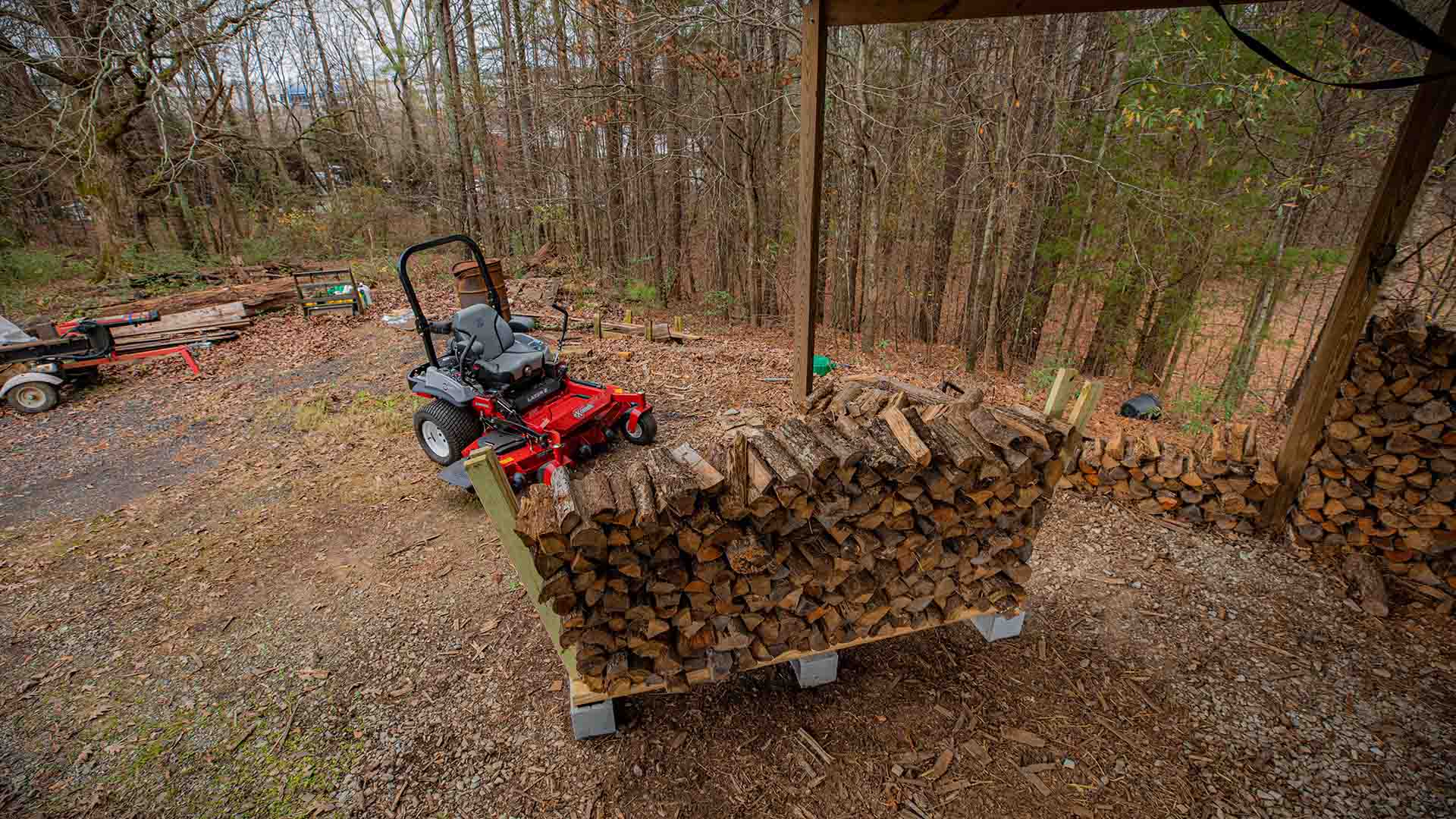 Firewood rack with Exmark mower behind it
