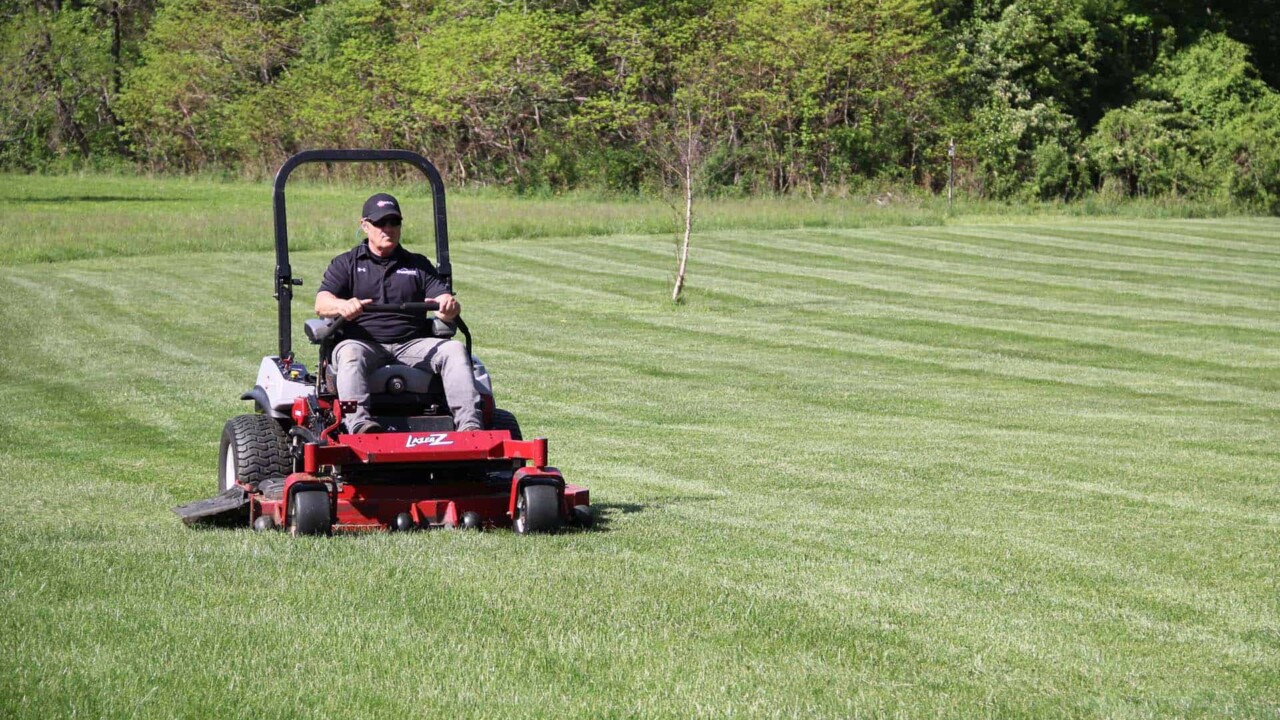 Joe Thomas using his Exmark mower to stripe his lawn