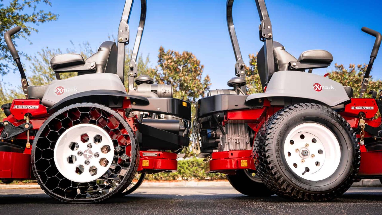 Two Exmark zero-turn mowers sitting back-to-back